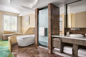 A modern bathroom with a bathtub, shower, and vanity. - Pasadena Hotel & Pool (Pasadena)