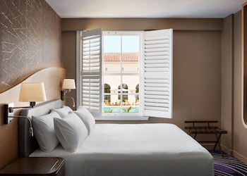 Deluxe Room, 1 King Bed, Pool View | In-room safe, desk, laptop workspace, iron/ironing board at Pasadena Hotel & Pool