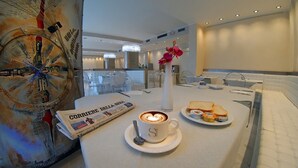A breakfast setting with a newspaper, coffee, and toast on a table. - Hotel Sporting Brugherio (Brugherio)