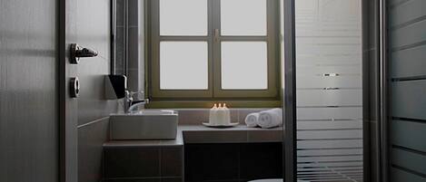 A bathroom with a window, a sink, and a toilet.
