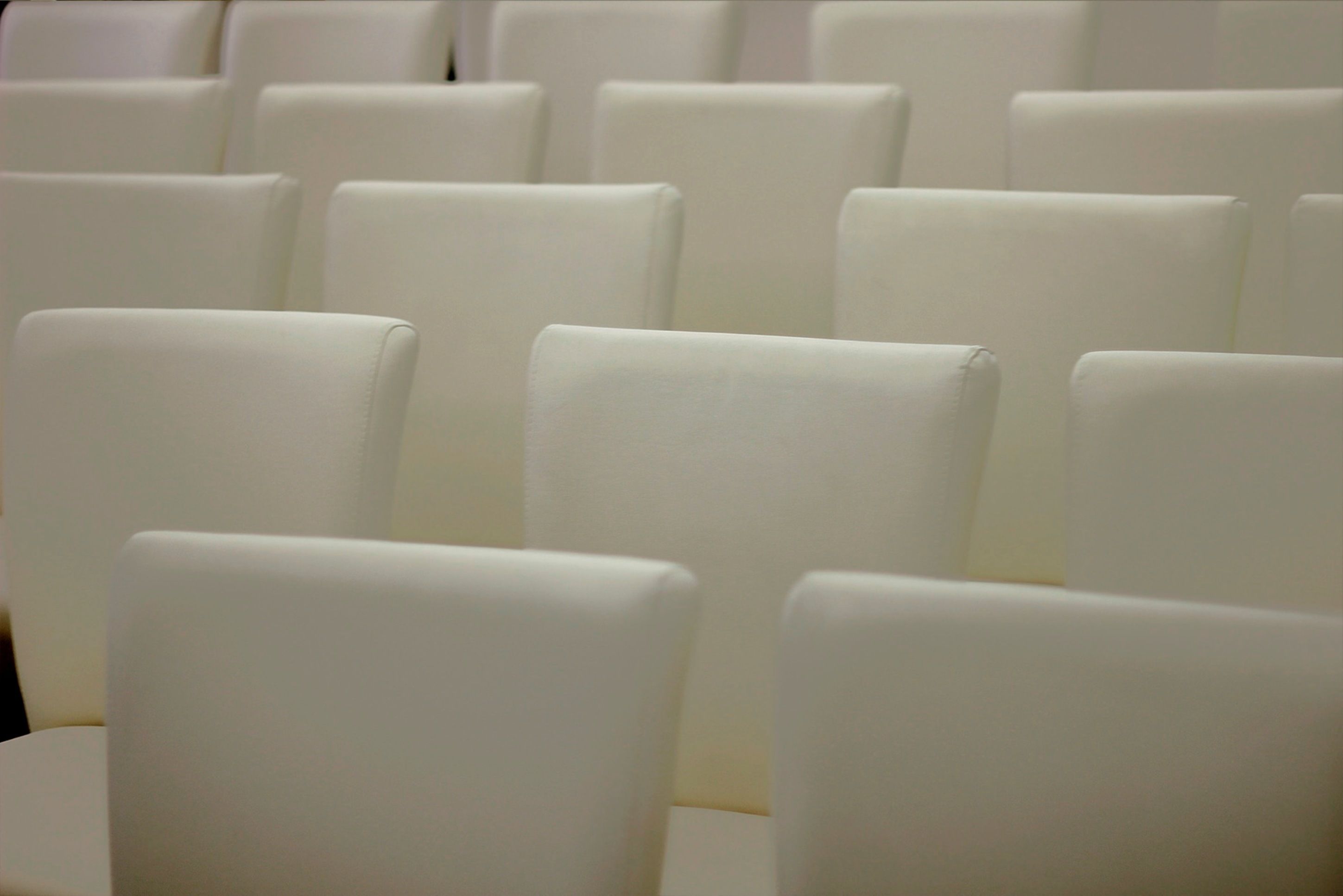 Rows of white chairs in a seating area.