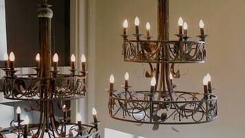 A chandelier with multiple tiers and candle-like lights.