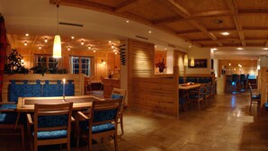 Un intérieur en bois comprenant un coin repas, des sièges et une cuisine.