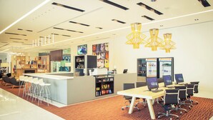 A modern office space with a reception area, bar, and seating. - Fiesta Inn Plaza Central Aeropuerto (Mexico City)
