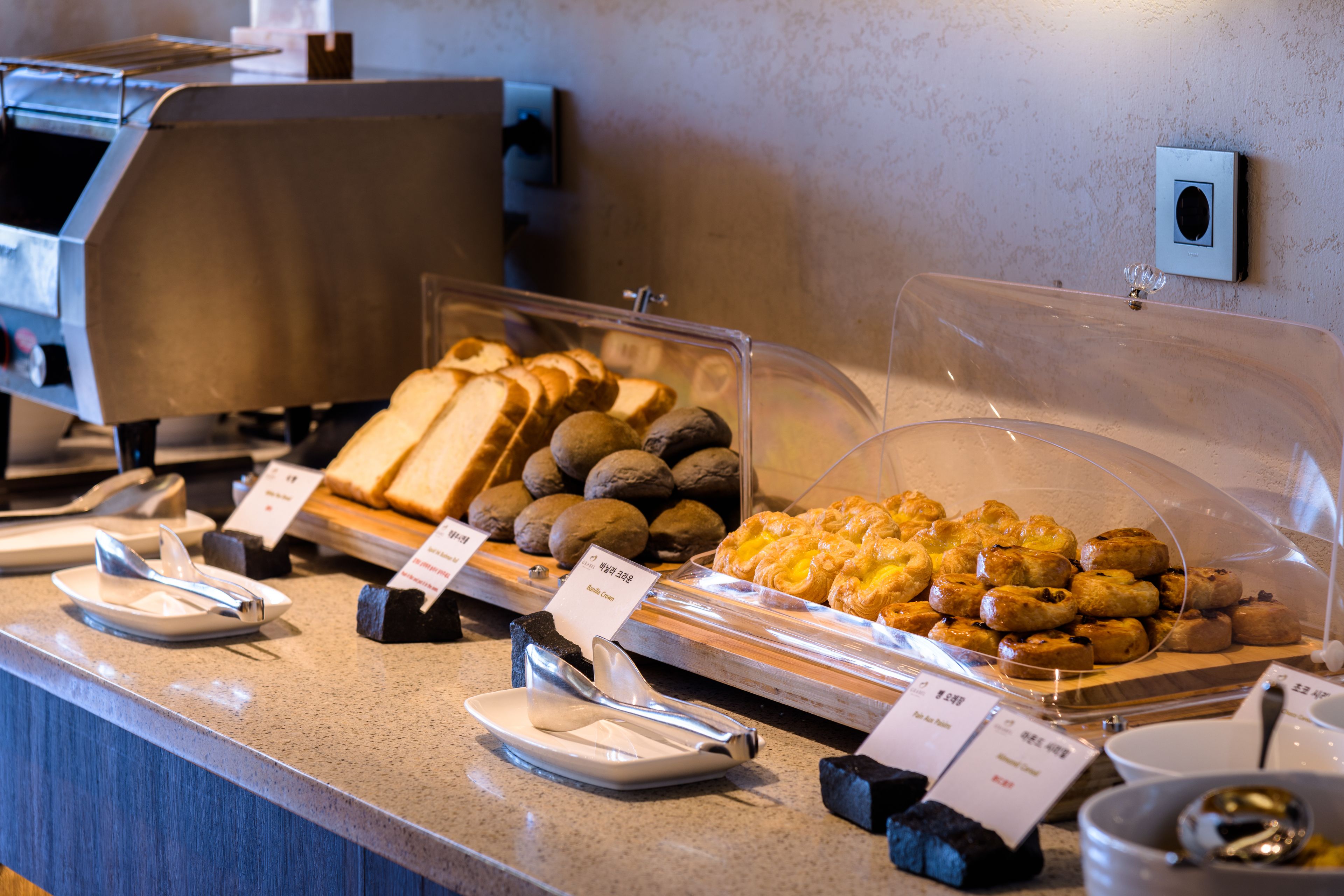A buffet with various food items and utensils.