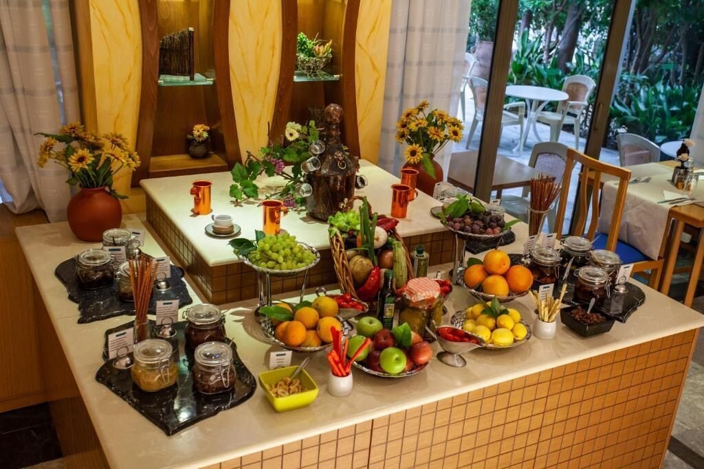 A buffet setup with various food items and condiments.
