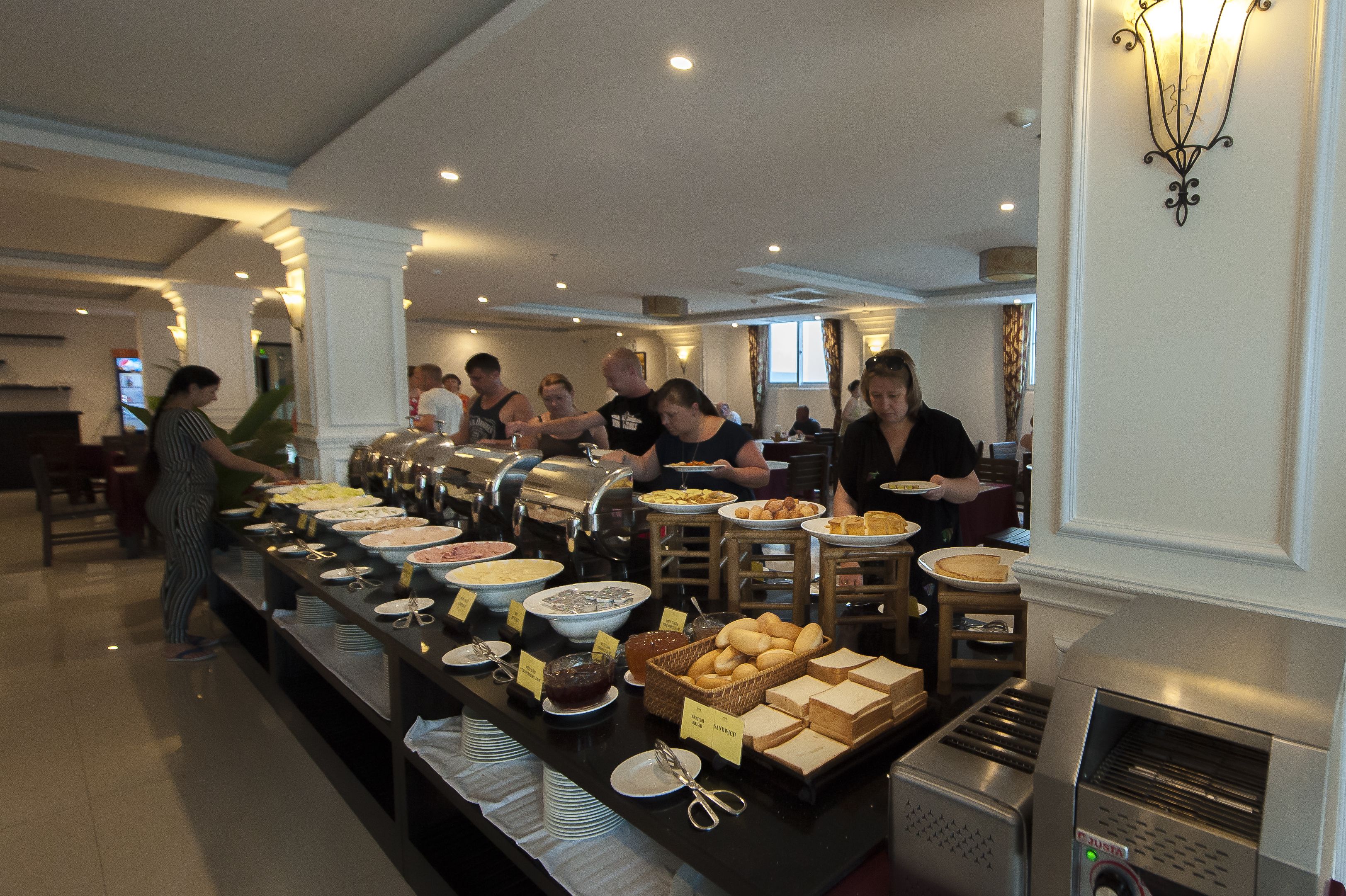 A buffet setup with various food items and a coffee machine.