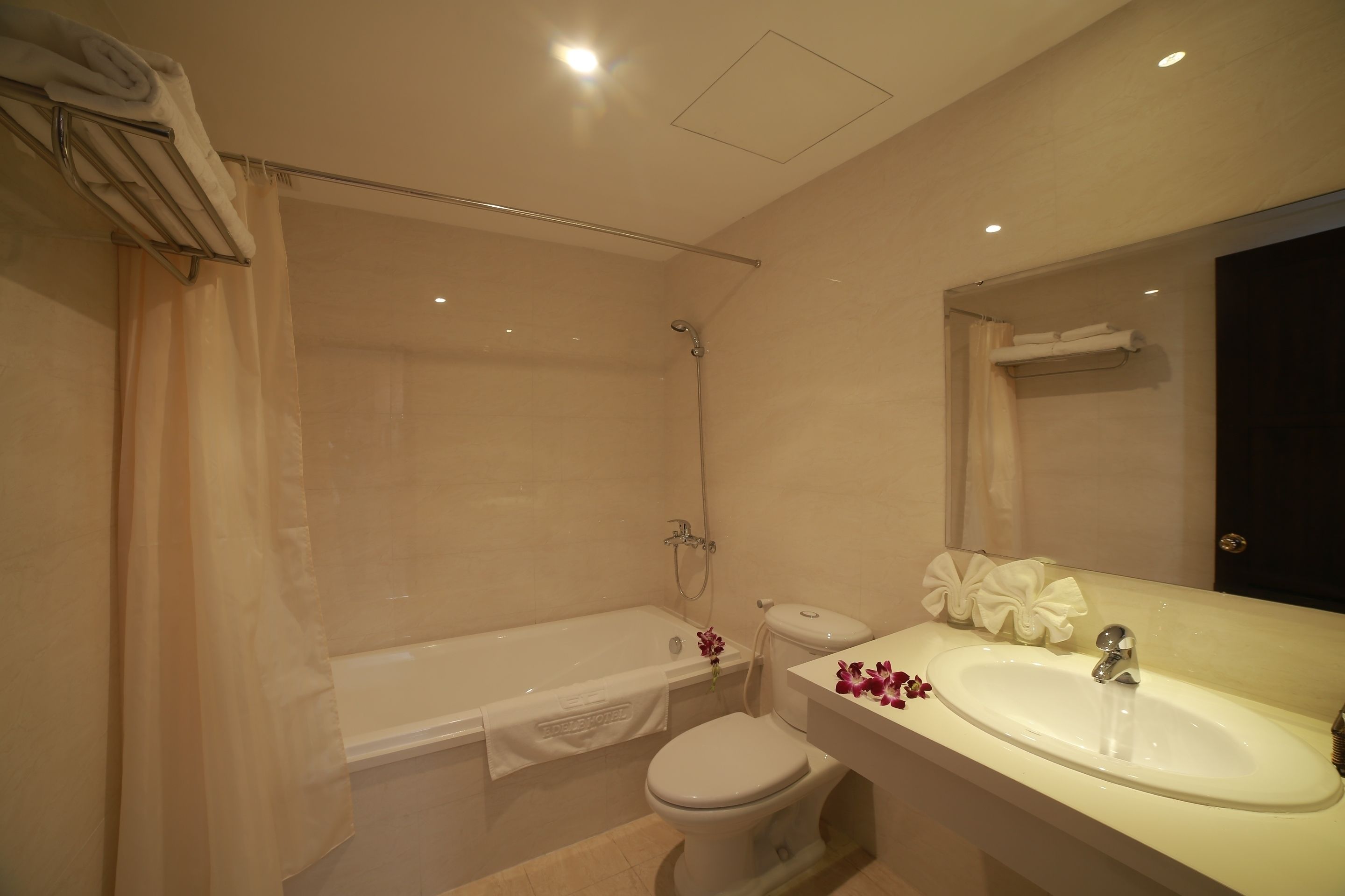 A bathroom with a bathtub, toilet, and sink.