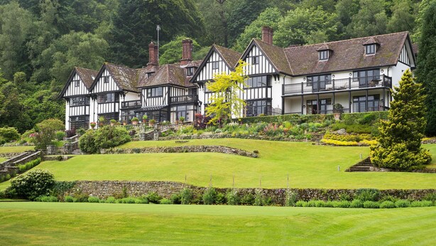A traditional Tudor-style building with multiple gabled roofs and a stone staircase leading to the entrance. - Gidleigh Park (Newton Abbot)
