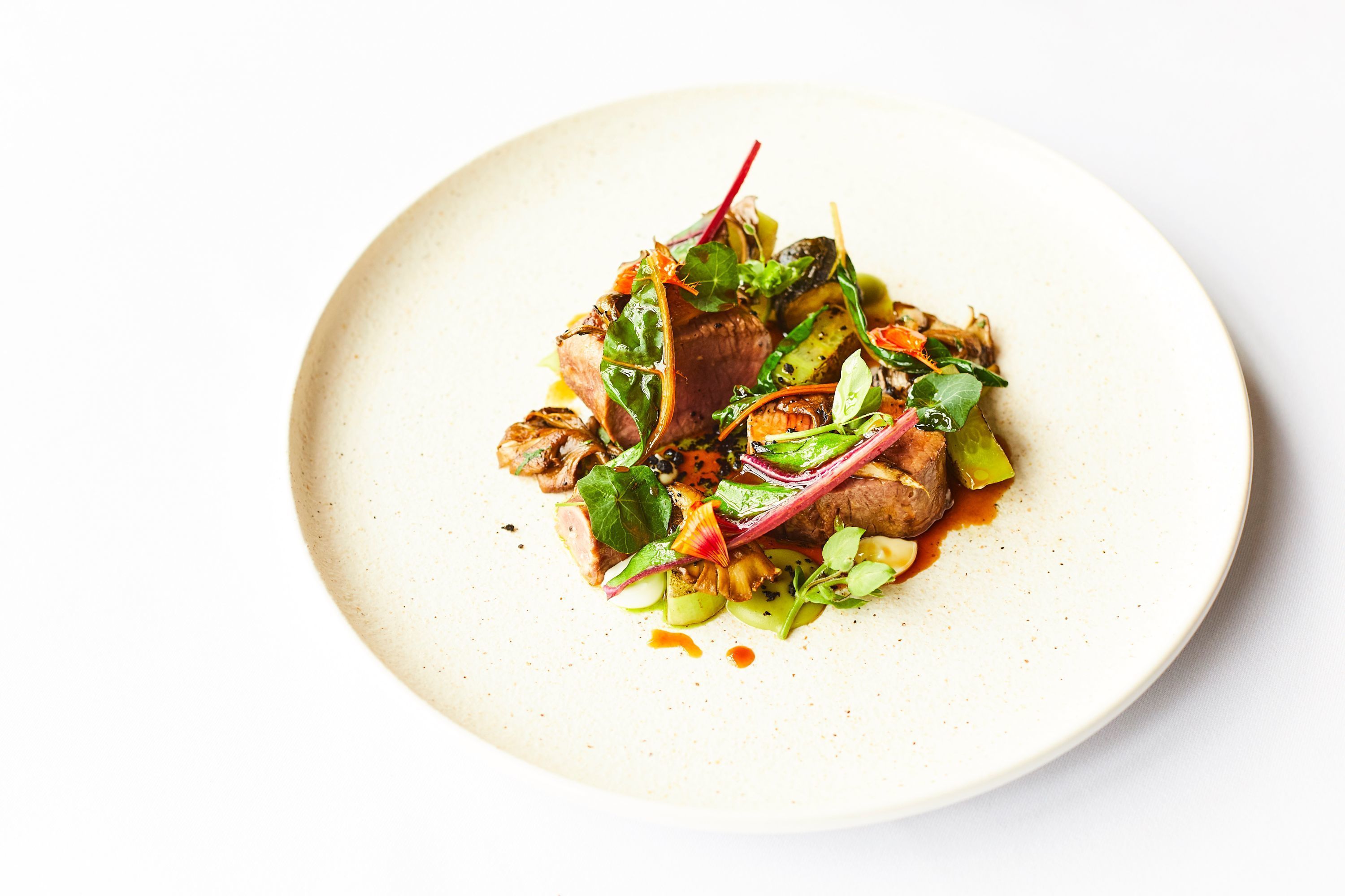 A plate of food with various vegetables and greens.