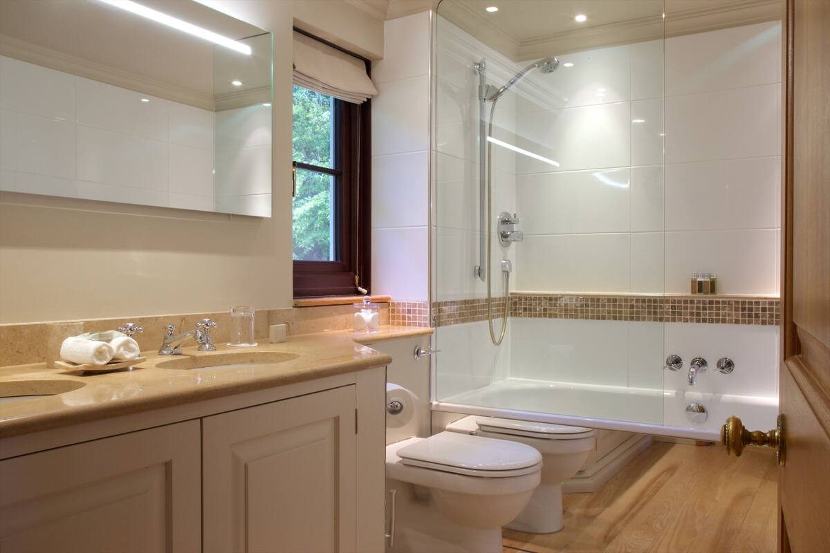 cottage | bathroom | designer toiletries, hair dryer, bathrobes, slippers