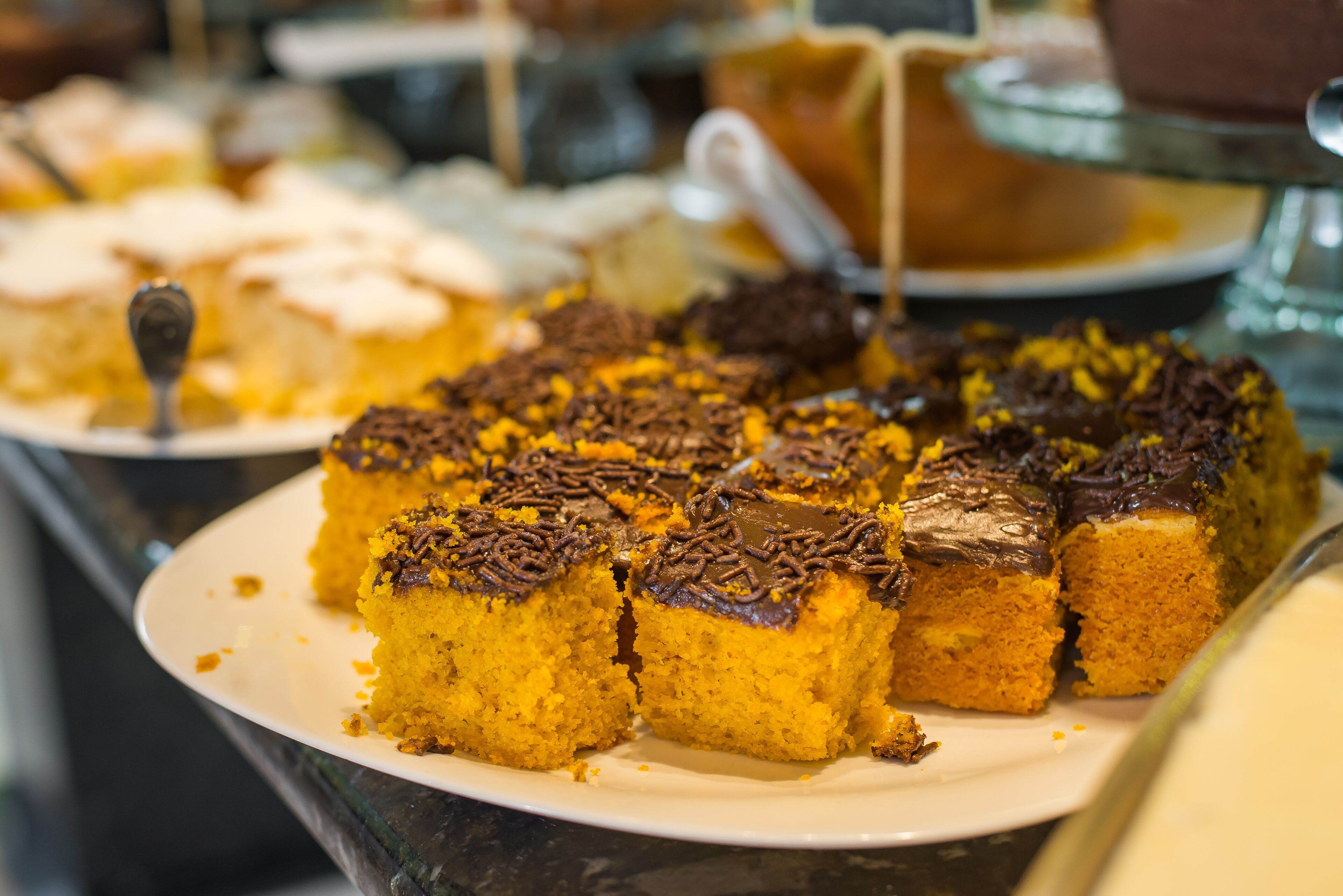 A dessert display with various cakes and pastries.
