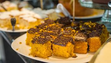 A dessert display with various cakes and pastries.