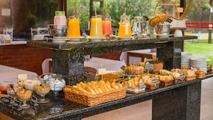 A buffet with various food items and beverages.