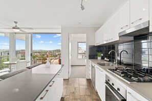 Governor - 2 Bedroom Apartment  | Private kitchen | Full-size fridge, microwave, oven, stovetop - Direct Collective - Pavilion and Governor on Brookes (Bowen Hills)