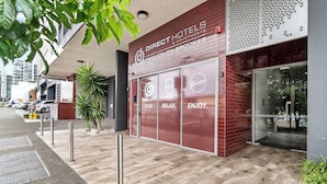 A hotel entrance with a sign for 'Direct Hotels Pavilion on Brookes' and a glass door. - Direct Collective - Pavilion and Governor on Brookes (Bowen Hills)
