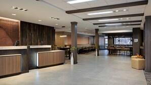 A spacious lobby with a reception desk, seating area, and a staircase. - Fairfield by Marriott Inn & Suites Moab (Moab)