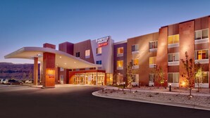 A Fairfield Inn & Suites Marriott hotel with a modern design, featuring a prominent entrance and a landscaped area with small trees. - Fairfield by Marriott Inn & Suites Moab (Moab)