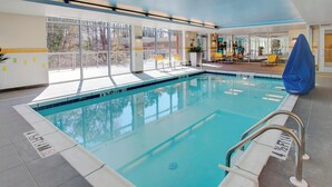 An indoor swimming pool with clear markings, a lifeguard chair, and a covered seating area. - Fairfield Inn & Suites by Marriott Rehoboth Beach (Rehoboth Beach)