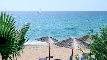 On the beach, sun-loungers, beach umbrellas, beach bar