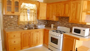 Apartment, 2 Bedrooms | Private kitchen | Full-size fridge, microwave, stovetop, cookware/dishes/utensils