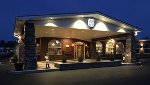 A hotel with a covered entrance, stone pillars, and a sign indicating it is a McDonald's restaurant. - Landmark Motor Inn (Fort Edward)