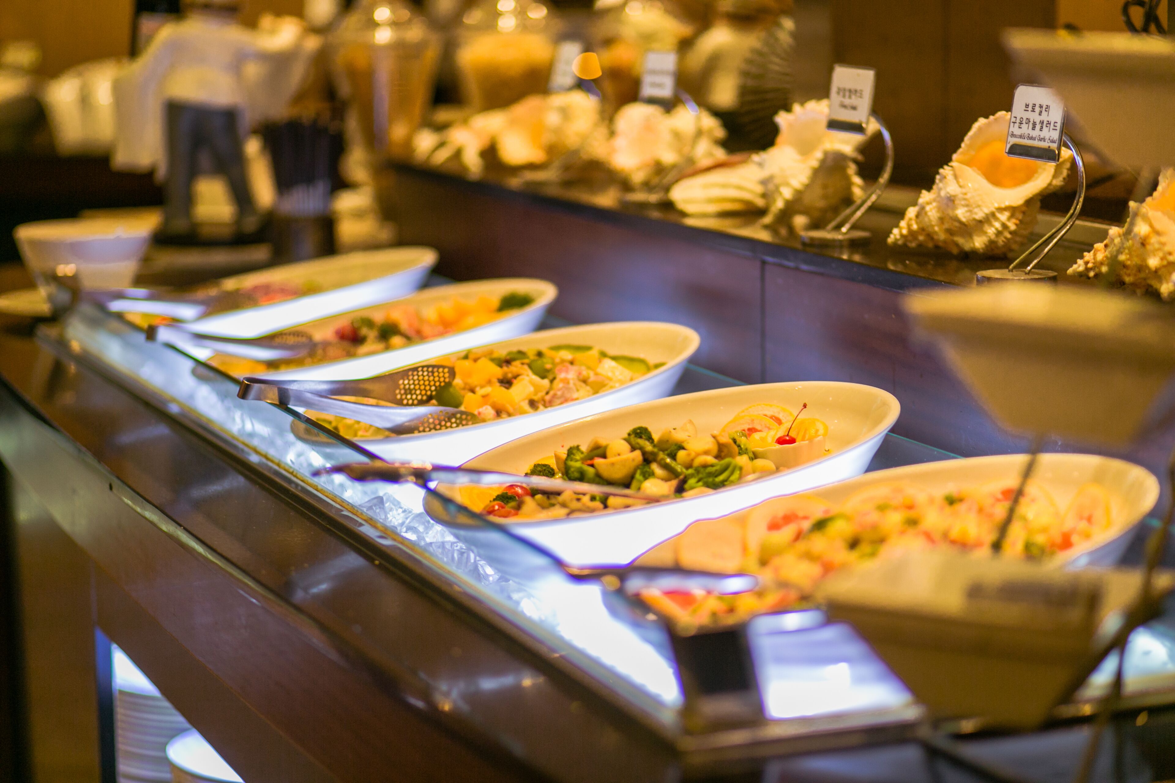 A buffet with various dishes displayed in bowls.