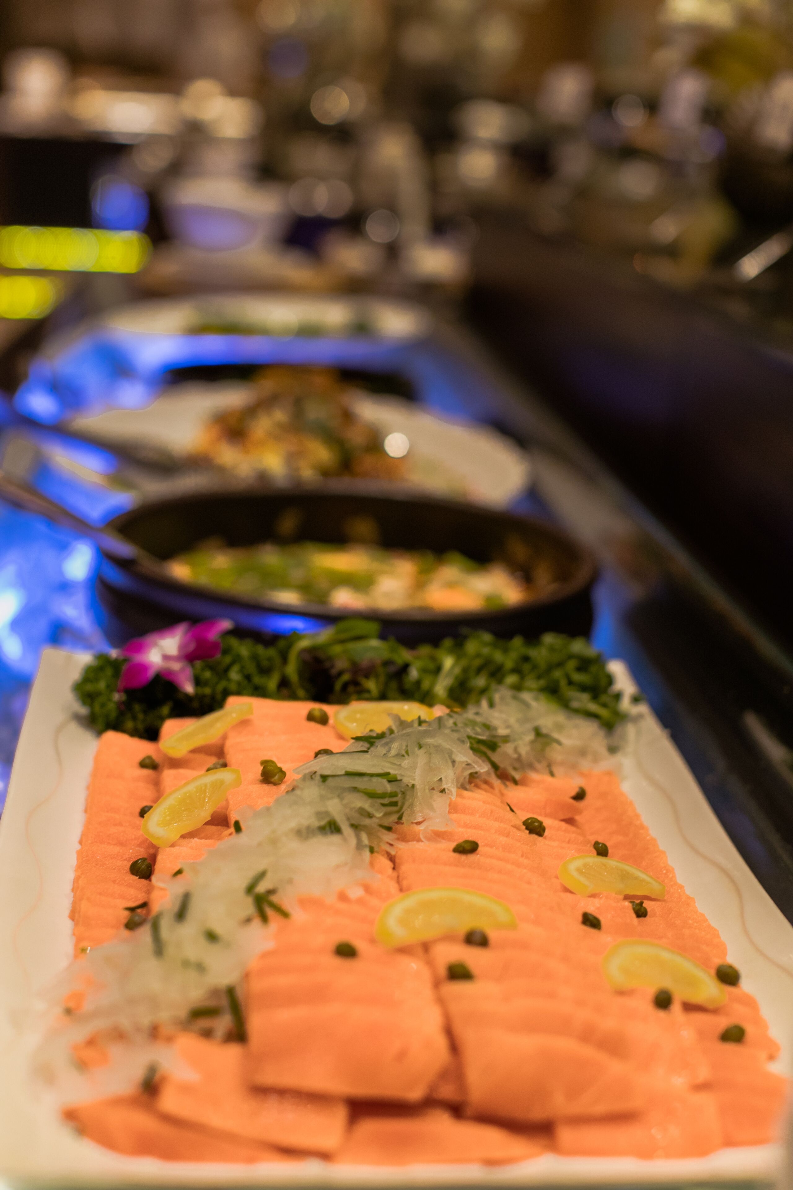 A buffet with salmon and other dishes.