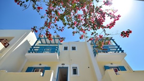 A multi-story building with blue balconies and white walls. - Kahlua Studios (Naxos)
