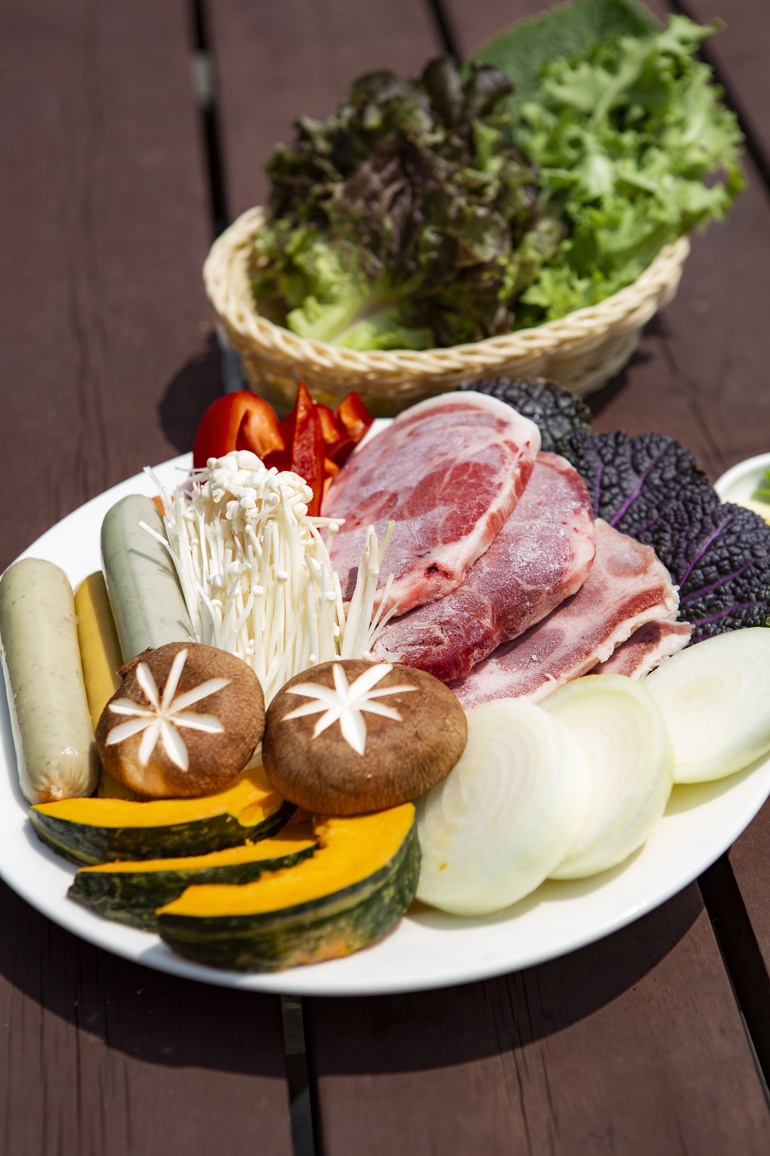 A plate of assorted foods including meats, vegetables, and mushrooms.