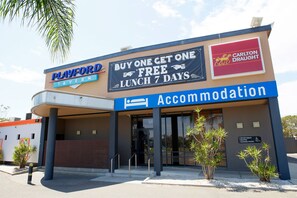 A Playford Tavern with a 'Buy One Get One Free Lunch 7 Days' sign, a Carlton Draught sign, and an 'Accommodation' sign.