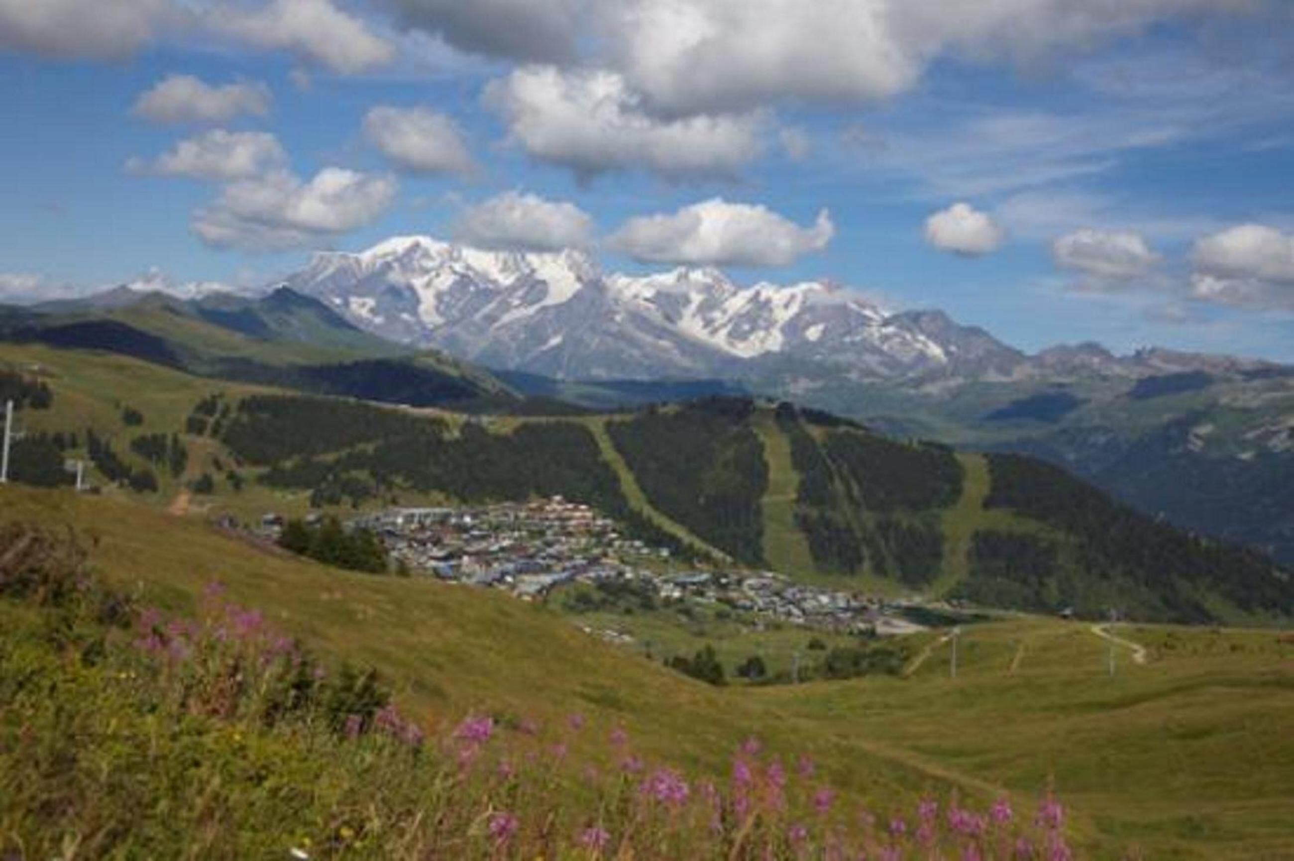 A mountainous landscape with a small settlement nestled in a valley.