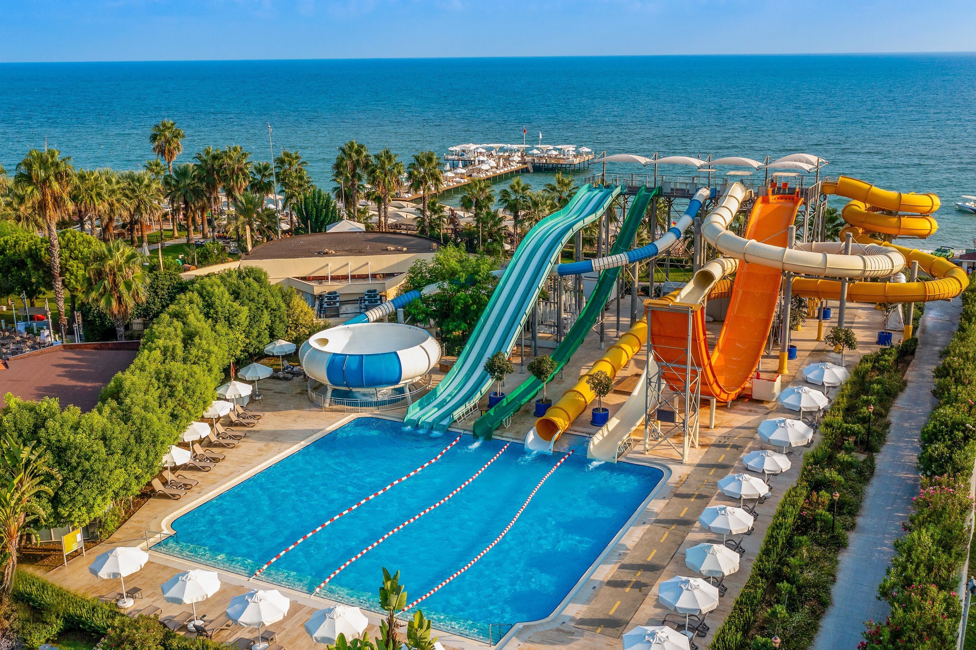 A water park with multiple slides and a swimming pool.