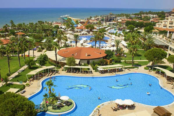 A resort with a large central swimming pool, multiple smaller pools, and a beach area. - Bellis Deluxe Hotel (Serik)
