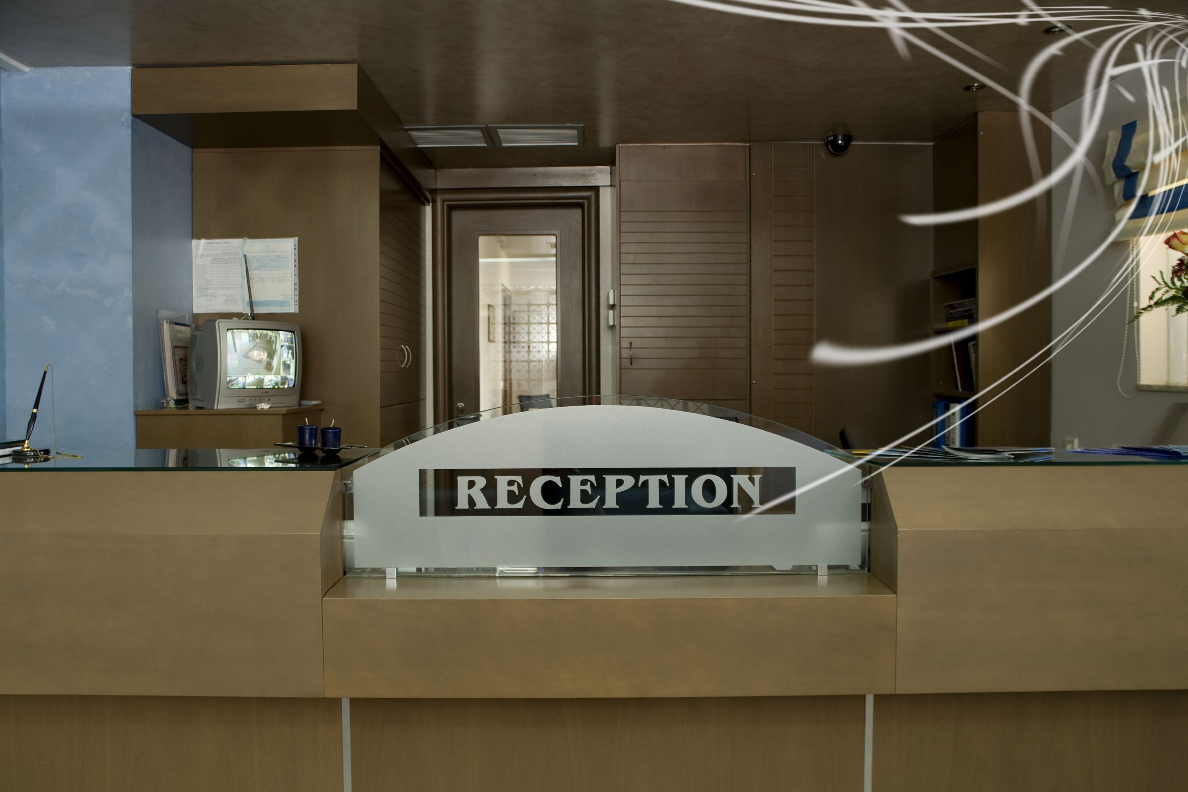 A reception desk with a sign that reads "RECEPTION".