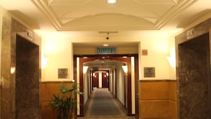 A hotel corridor with a sign for 'KELUAR' and 'ROOM AIRPORT'. - Grand Service Suite at Times Square (Kuala Lumpur)