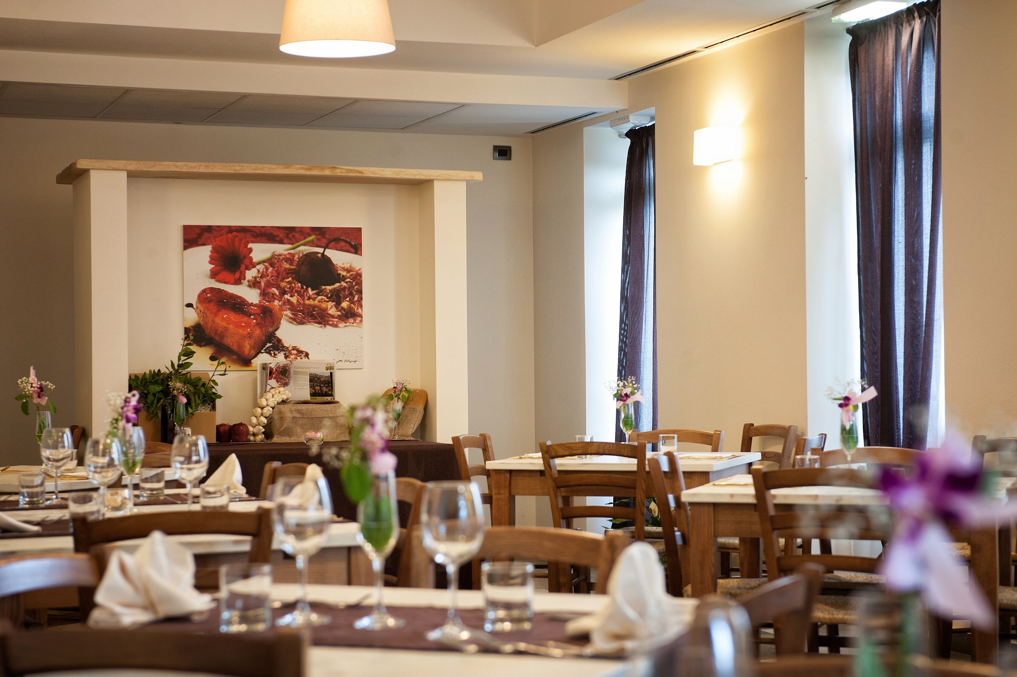 A dining area with wooden tables and chairs, arranged for service.