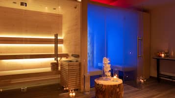 Relax in a serene spa room with a sauna, wooden bench, and candlelit ambiance.
