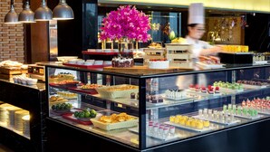 A buffet with various food items and a chef preparing food. - Angsana Xi'an Lintong (Xi'an)