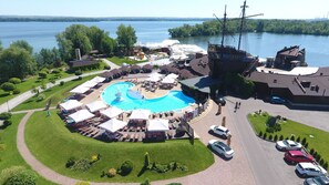 An aerial view of a resort with a central swimming pool, outdoor seating, and a large ship replica. - Bartolomeo Best River Resort (Dnipro)