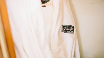 A white robe with a patch that reads "Vintage Trailer Resort."