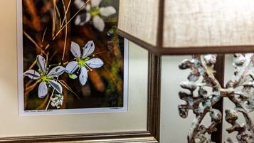 A framed photograph of flowers on a wall.
