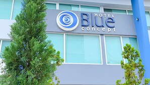 The exterior of the Blue Hotel Concept with a modern design, large windows, and potted plants in front. - The Blue Hotel. (Cartagena)