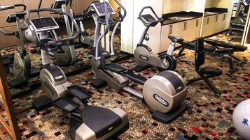 A gym with various exercise machines, including treadmills and elliptical trainers.