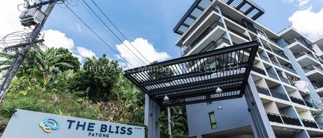 A modern building with a sign reading "THE BLISS PATONG".