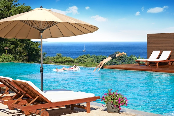 Seasonal outdoor pool, open 10:00 AM to 10:00 PM, pool umbrellas