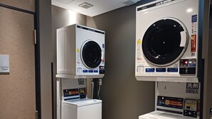 A hotel laundry room with two front-loading washing machines and a dryer. - APA Hotel Higashi Shinjuku Kabukicho (Tokyo)