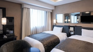 A hotel room with two beds, a desk with a telephone, a chair, a television, and a large mirror. - APA Hotel Higashi Shinjuku Kabukicho (Tokyo)