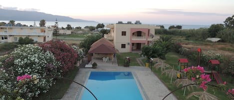Seasonal outdoor pool, open 8:00 AM to 7:00 PM, pool umbrellas