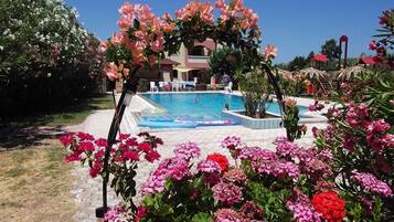 Seasonal outdoor pool, open 8:00 AM to 7:00 PM, pool umbrellas